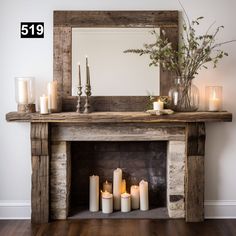 a fireplace with candles and a mirror on it