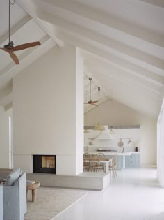 a living room filled with furniture and a fire place in the middle of a room