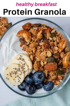 a glass bowl filled with granola and blueberries next to yogurt, banana slices