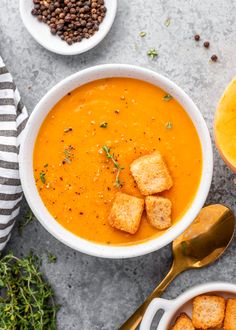 bowls of soup with croutons on the side