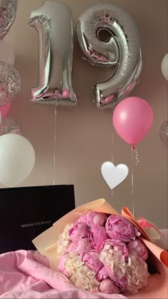 a bouquet of flowers and balloons in front of the number twenty five balloon wall decoration