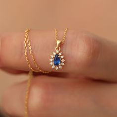 Dazzle her with this stunning Real Diamond Sapphire Drop Necklace, intricately set in luxurious 14K Solid Gold. A timeless beauty and September's birthstone, this pendant is the perfect token of love for Mother's Day, your girlfriend, or wife. Authentic elegance, forever cherished. Sapphire symbolizes loyalty, love and longing. It gives positive vitality with the wonderful energy given by its color. Our 14K Solid Gold Drop sapphire necklace surrounded by diamonds is suitable for daily use. A sty Pear-shaped Diamond Birthstone Necklace, Elegant Pear-shaped Birthstone Jewelry, Pear-shaped Sapphire Jewelry Gift, Pear-shaped Cubic Zirconia Birthstone Jewelry, Pear-shaped Sapphire Necklace For Wedding, Gold Sapphire Necklaces For Wedding, Sapphire Necklace With Prong Setting For Wedding, Gold Sapphire Necklace For Wedding, Yellow Gold Sapphire Necklaces For Wedding