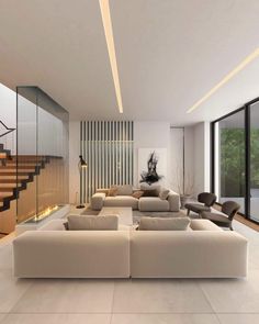 a living room filled with lots of white furniture and tall glass windows on the wall