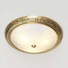 an ornately designed ceiling light in gold