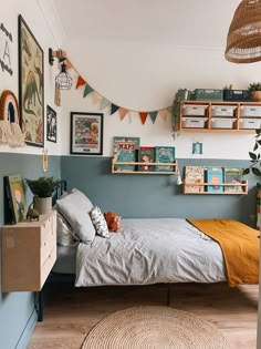 a bed room with a neatly made bed and pictures on the wall