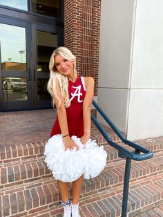 a woman in a red shirt and white tutu skirt