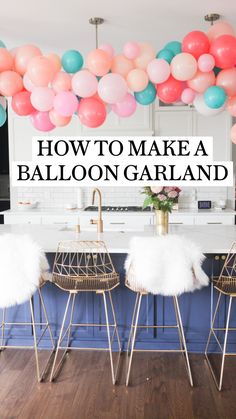 balloons are hanging over the kitchen island in this modern, white and blue kitchen with gold stools