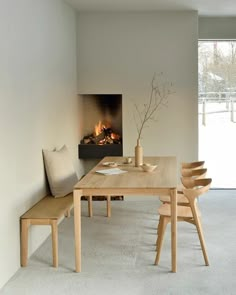 a dining room table with chairs and a fire place