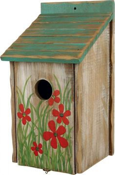 a birdhouse with red flowers painted on it