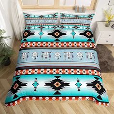 a bed room with a neatly made bed covered in colorful comforter and pillow cases