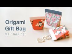 an origami gift bag is sitting on the table with keychain attached to it