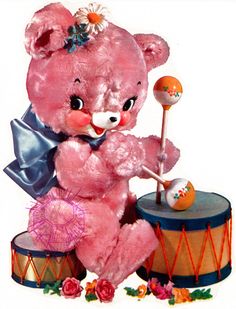 a pink teddy bear sitting on top of a drum and holding a candy bar in it's mouth