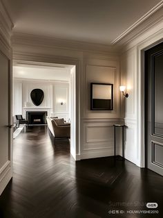 an empty room with white walls and wood floors is seen in this image from the doorway