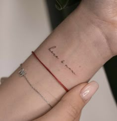 a woman's wrist with a name tattoo on it