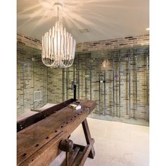 a large wooden table with a chandelier hanging from it