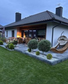 a house that has some plants in the front yard and grass on the ground around it