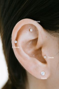 a woman's ear is shown with three different piercings on the top and bottom