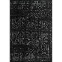 a black rug with an intricate design on the front and back side, in dark colors