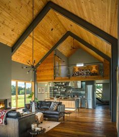 the inside of a house with wood ceilings and windows, including an open floor plan