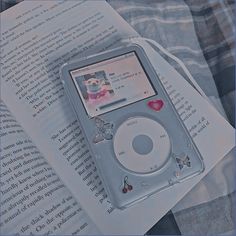 an ipod sitting on top of a book