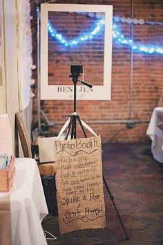 an easel with a sign on it in front of a brick wall and blue lights