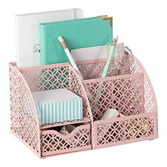 a pink desk caddy with pens, notebooks and other office supplies