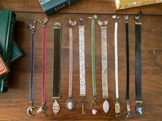 there are many different types of bracelets on the table next to books and other items