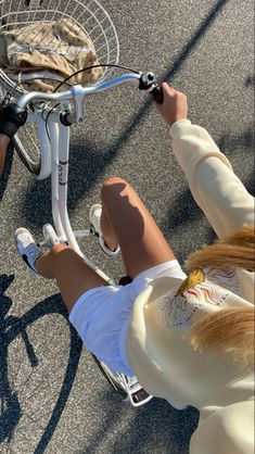 a person riding a bike with a basket attached to it's handlebars