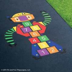 a child's play area with numbers and shapes painted on the ground