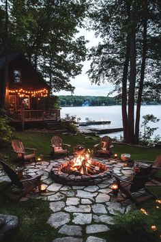 Cozy lakeside cabin with a fire pit, surrounded by Adirondack chairs and glowing lanterns. Fire Pit Decorating Ideas Seating Areas, Patio Decorating Ideas Fire Pits, Backyard Fire Pit With Lights, Rustic Outdoor Seating Ideas, Big Fire Pit Ideas Backyard, Backyard Stone Fire Pit Ideas, Backyard Fire Pit Area Landscape Design, Landscaping Fire Pit Ideas, Giant Fire Pit