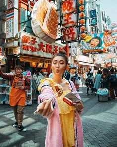 a woman dressed in traditional chinese clothing holding food