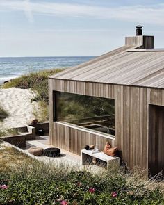 a beach house with a hot tub in the sand