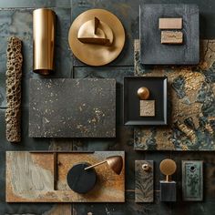 an assortment of decorative items displayed on a wall with gold, black and grey accents