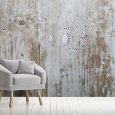 a chair sitting in front of a concrete wall