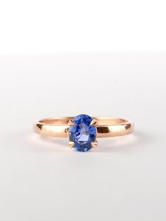 a gold ring with a blue sapphire stone