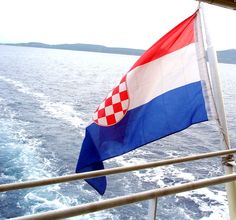 the flag is flying on the back of a boat