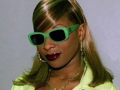 a woman with green sunglasses on her face