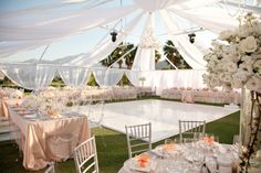 an outdoor wedding reception setup with tables and chairs