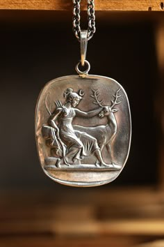 Guardian of young and fragile life, Artemis shown with several of her symbols including a bow, arrows and the stag. The pendant is crafted in sterling silver in out Los Angeles studio. Artemis Symbol, Artemis Altar, Hellenic Polytheism, Artemisia Vulgaris, Goddess Of The Hunt, Metal Magic, Artemis Goddess, Greek Goddesses, The Stag