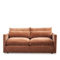 a brown couch sitting on top of a white floor