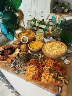 a wooden table topped with lots of different types of snacks and condiments on top of it