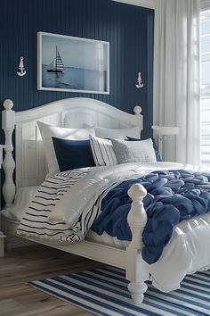 a bedroom with blue walls and white furniture