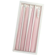 three pink candles in a white box