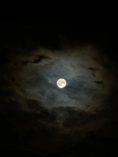 the moon is shining brightly in the dark night sky with fluffy clouds and black background