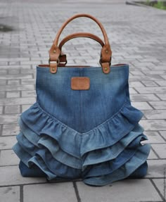 a handbag made out of jeans on the ground