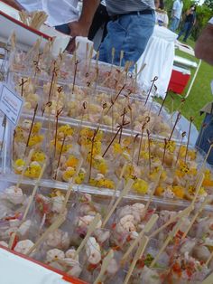 several trays filled with food sitting on top of a table