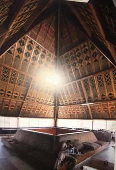 the inside of a building with wooden beams