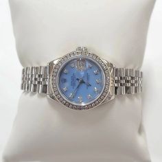 Women's Rolex 26mm DateJust Stainless Steel Watch with Powder Blue Diamond Dial and Diamond Bezel. Pre-Owned Brand: Rolex. Crystal: Sapphire. Dial: Diamond Dial. Gender: Women's. Dial Color: Powder Blue. Movement: Self-Winding. Case Dimensions: 26mm. Metal Type: Stainless Steel. Bezel: Custom Diamond Bezel. Bracelet / Strap: Original Jubilee. Box / Certificate: Rolex Box / Certificate of Authenticity. Service Warranty: One (1) Year Limited Service Warranty. NOTE: This beautiful Rolex watch inclu Blue Diamond Watch With Round Dial, Elegant Blue Watch Accessories With Diamond Hour Markers, Blue Diamond Chronometer Watch For Formal Occasions, Formal Blue Diamond Watch With Chronometer, Blue Diamond Watch With Round Subdials, Blue Diamond Watch With Subdials, Timeless Blue Diamond Watch With Chronometer, Blue Diamond Watch With Diamond Hour Markers For Anniversary, Formal Blue Diamond Watch With Subdials