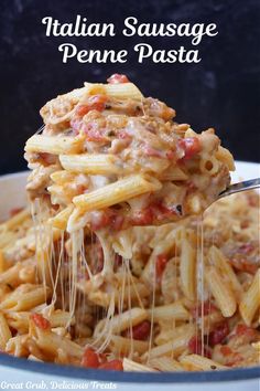 a pasta dish with meat and sauce being lifted from a white casserole dish