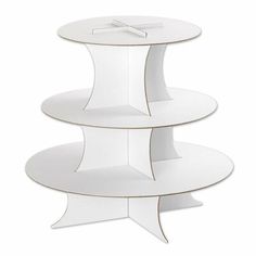 three tiered cake stand in white with a cross on the top and bottom shelf